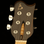 Headstock detail, chambered body. Carved bookmatched Flamed Maple top featuring original Basone f-hole.