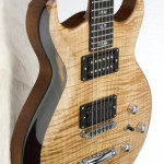 Carved double cut-away solid Honduran Mahogany body with flame Maple carved top, featuring custom Indian Ebony bevel.